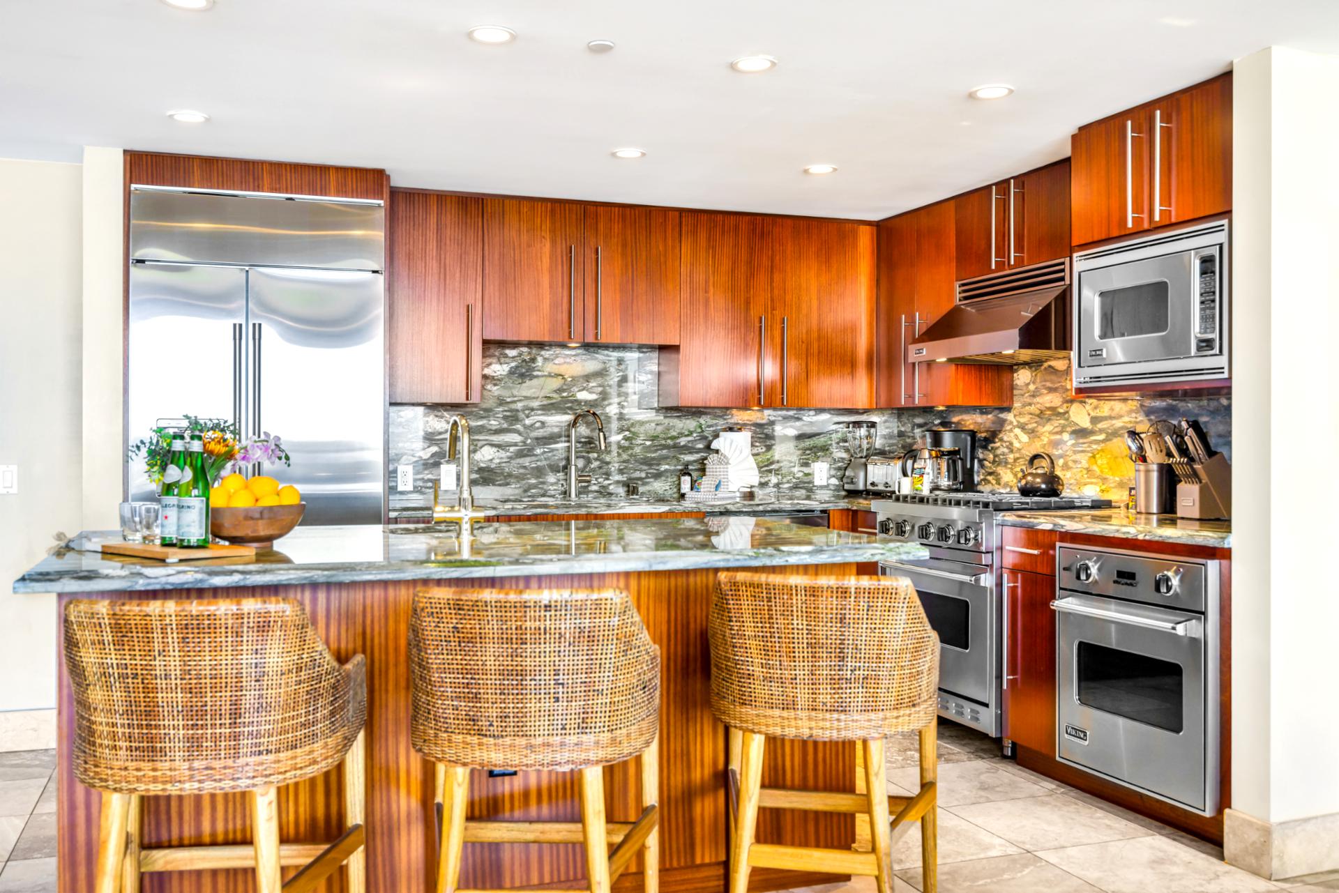 Your fully equipped kitchen features stainless appliances, granite counters, and bar seating for effortless meals at home.