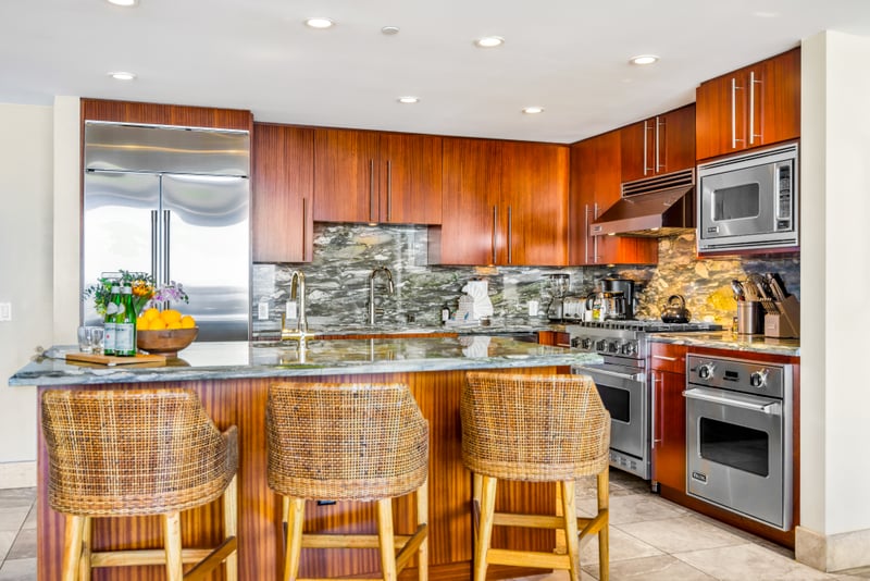 Your fully equipped kitchen features stainless appliances, granite counters, and bar seating for effortless meals at home. HKH-529