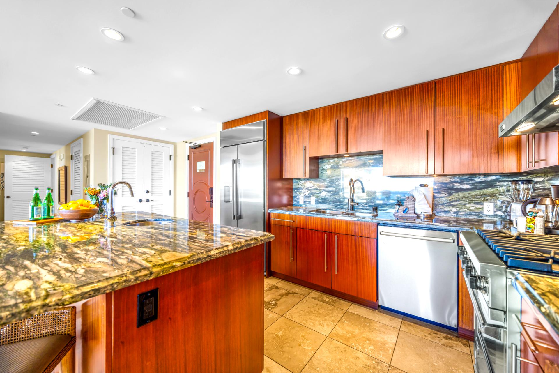 A spacious island with bar seating offers the perfect spot for breakfast or evening drinks before heading out.