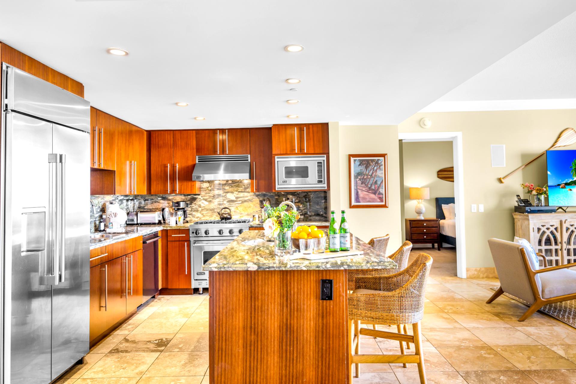 Fully equipped kitchen with wine fridge, double ovens, and rich wood cabinetry. Ideal for everything from quick bites to family dinners.