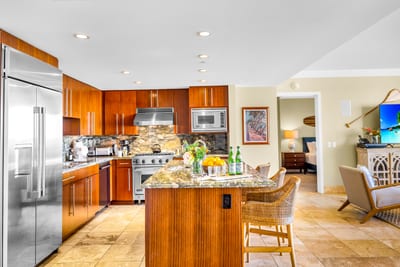 Fully equipped kitchen with wine fridge, double ovens, and rich wood cabinetry. Ideal for everything from quick bites to family dinners. HKH-529