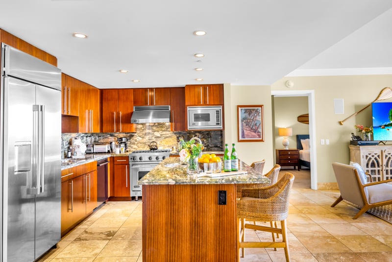 Fully equipped kitchen with wine fridge, double ovens, and rich wood cabinetry. Ideal for everything from quick bites to family dinners. HKH-529