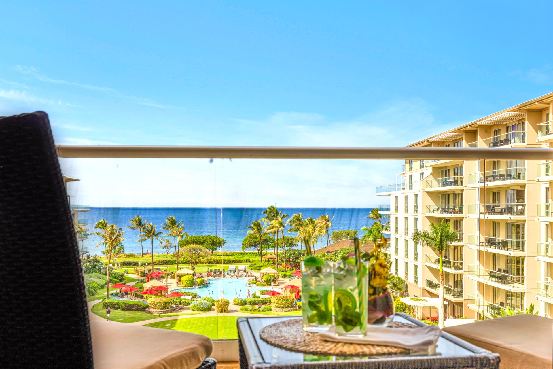 Sip cocktails with unobstructed ocean views from your balcony perch above Honua Kai's tropical grounds.