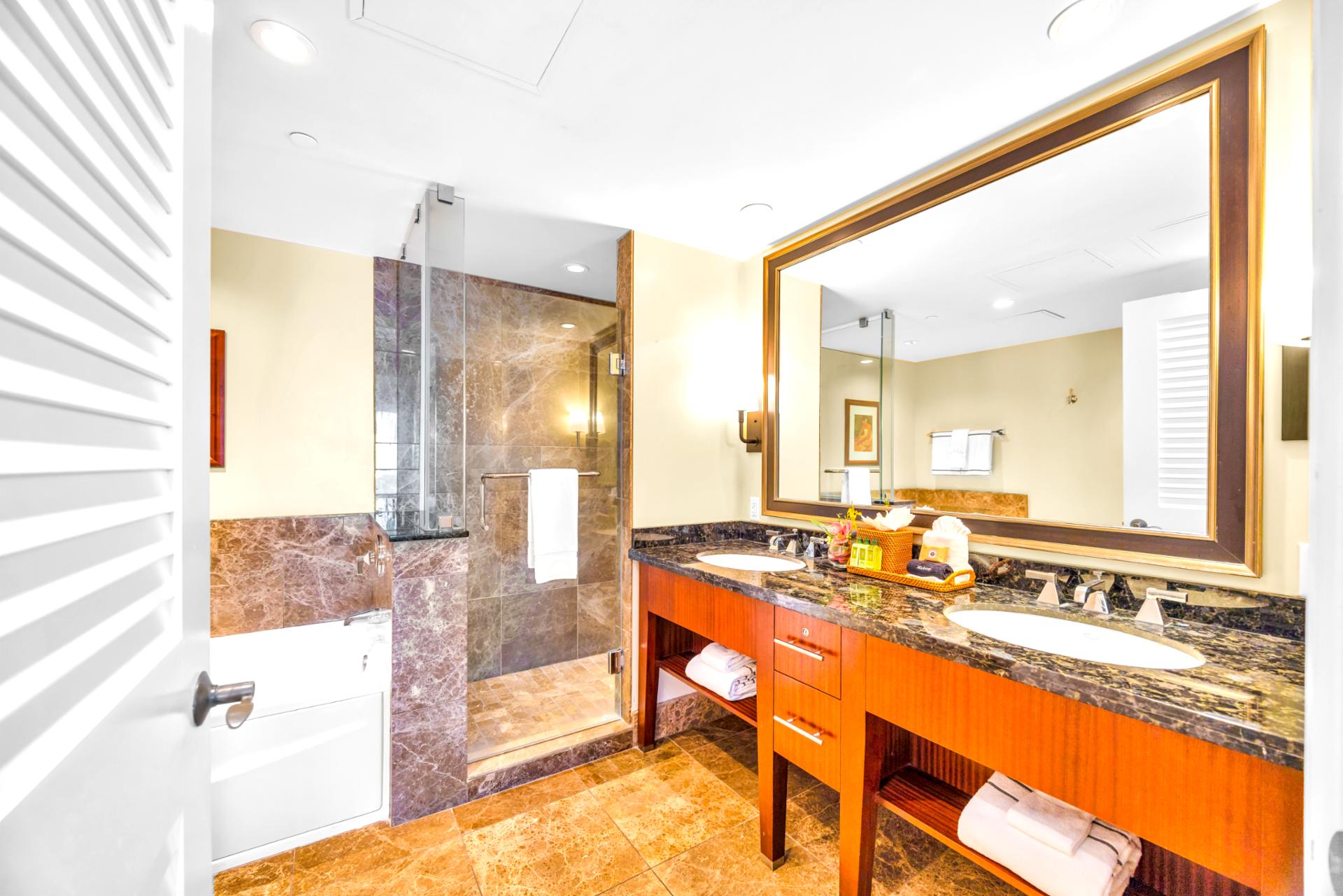 Refresh in your spa-style bath with granite dual vanity, soaking tub, and a large walk-in shower with rainfall glass.