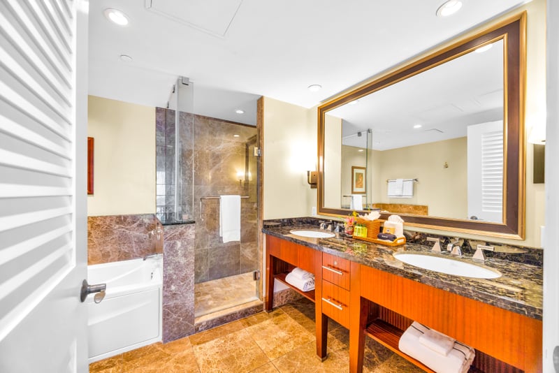 Refresh in your spa-style bath with granite dual vanity, soaking tub, and a large walk-in shower with rainfall glass. HKH-529
