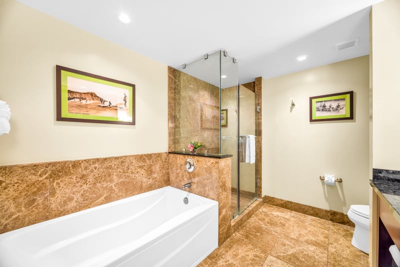 Guest Bath 1 offers a full layout with granite counters and a mix of tub and walk-in shower.
