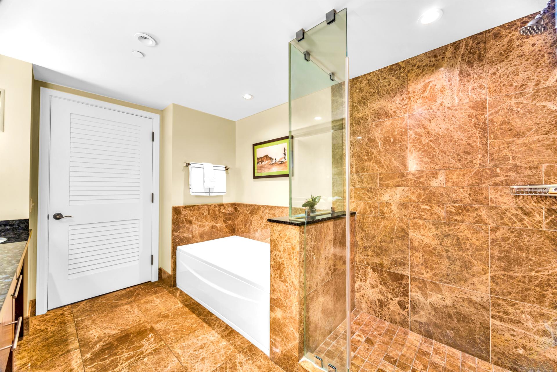 Marble accents and a soaking tub in Guest Bath 1 invite you to slow down and recharge.
