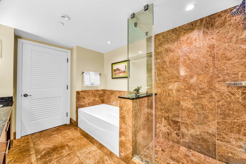 Marble accents and a soaking tub in Guest Bath 1 invite you to slow down and recharge.