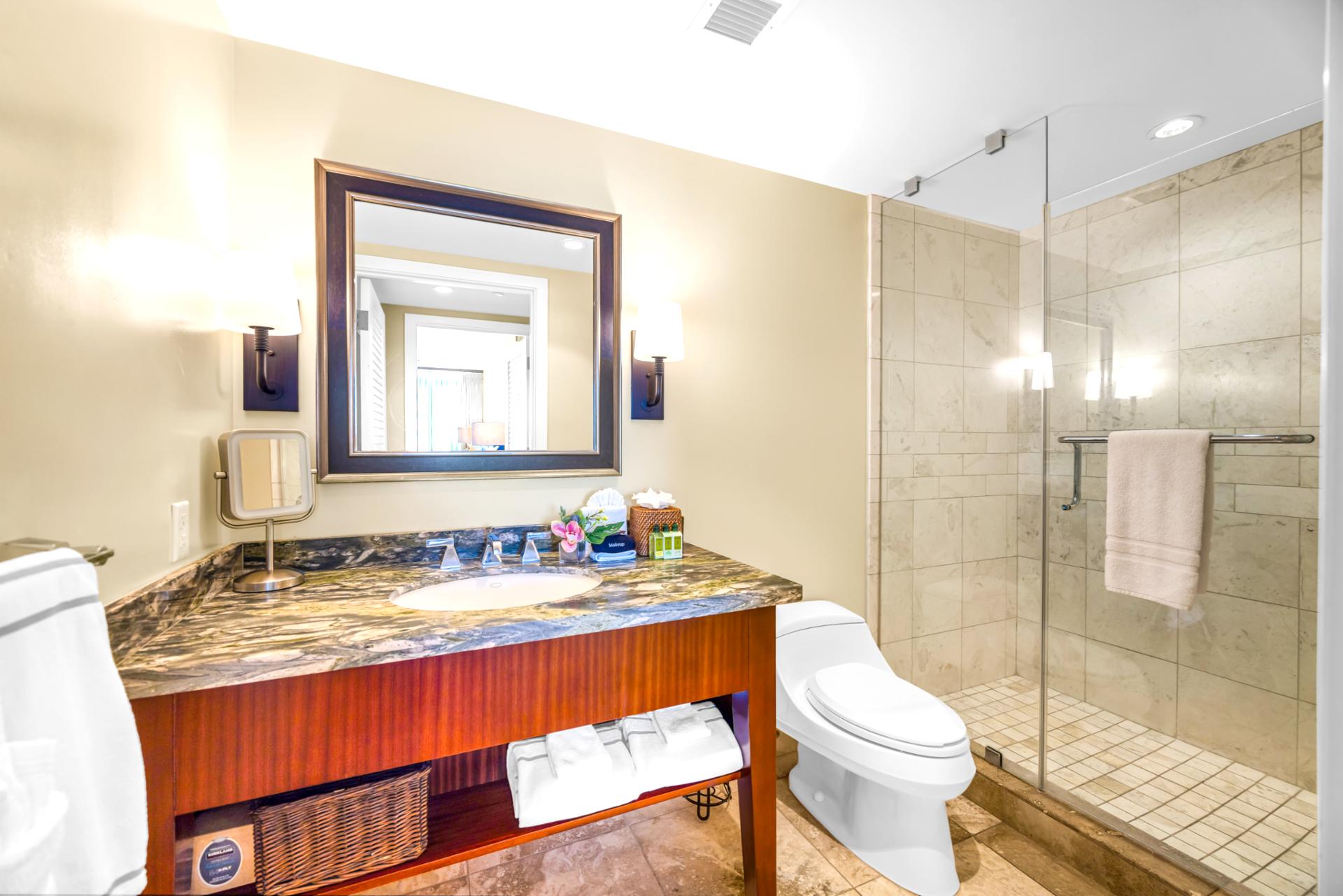A glass walk-in shower and granite vanity complete this well-appointed second bathroom.