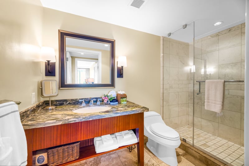 A glass walk-in shower and granite vanity complete this well-appointed second bathroom.