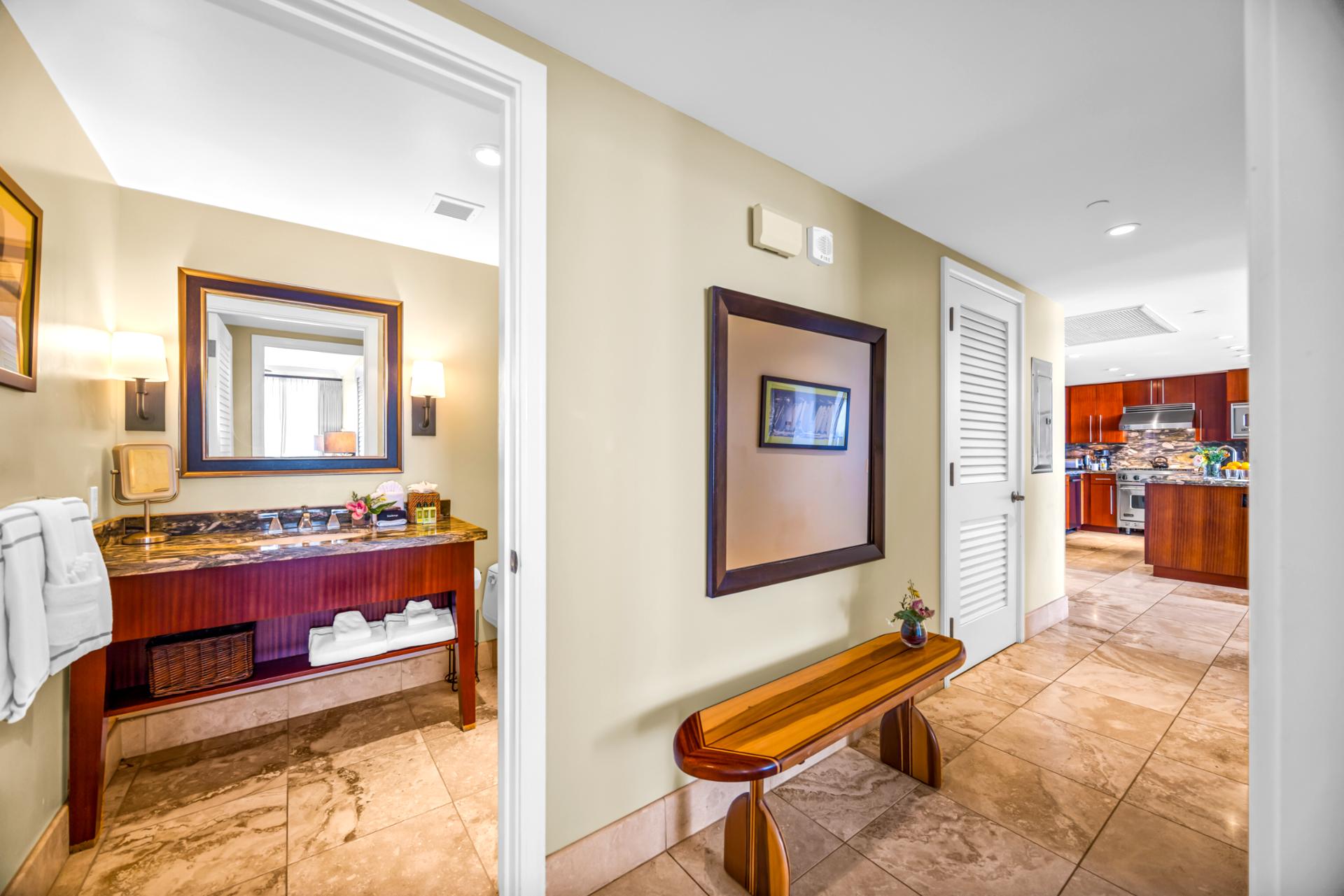 The second full bath features granite counters and a spacious layout conveniently located near the guest bedroom.