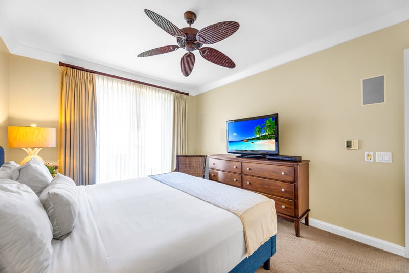 Wake up to natural light and your own private TV setup in this spacious primary suite with direct balcony access. HKH-529