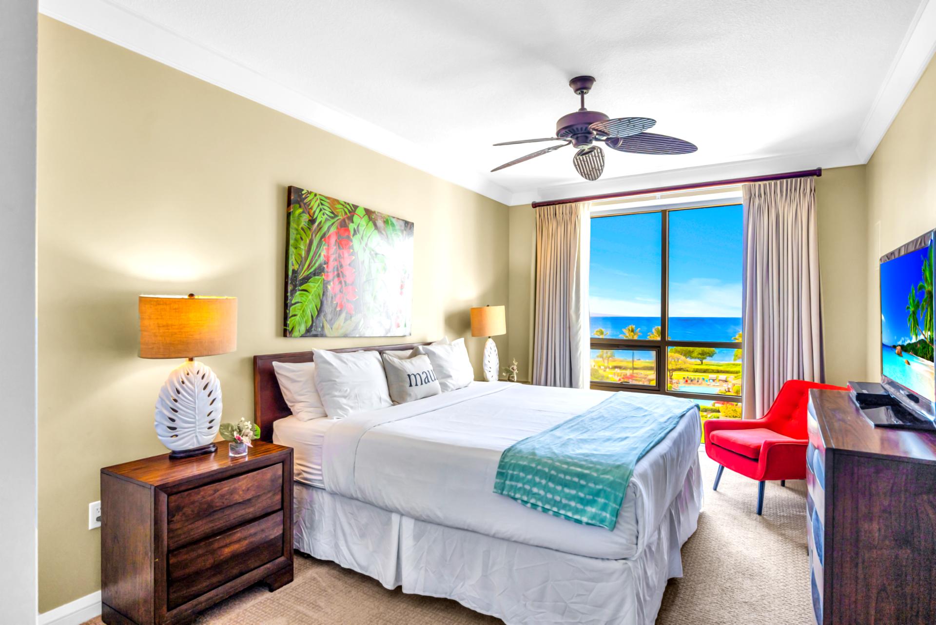 Enjoy ocean peeks from your guest room with a Queen bed, Smart TV, and vibrant island artwork.