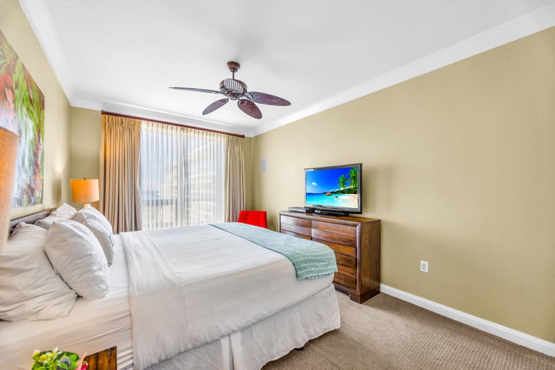 The guest bedroom includes a Queen bed, dresser, and TV, perfect for winding down after your day in the sun. HKH-529