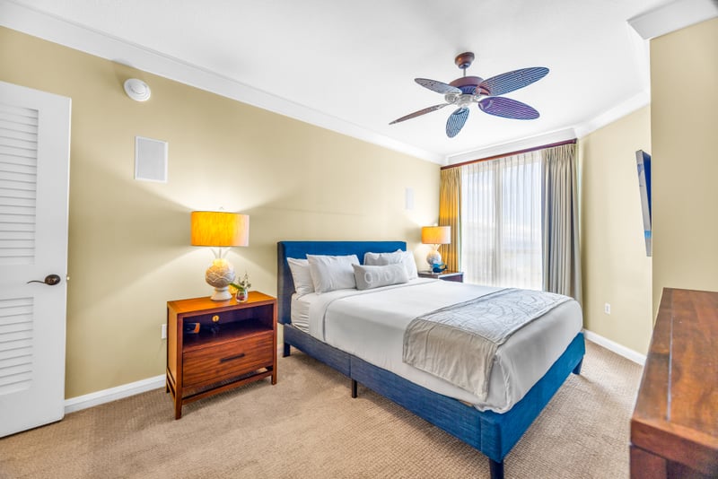 Guest Bedroom 1 features a King bed, warm lighting, and a ceiling fan, comfortable and quiet after sunset strolls. HKH-529