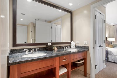 Stylish double-sink vanity connects seamlessly to plush, inviting bedroom retreat. HKH-545