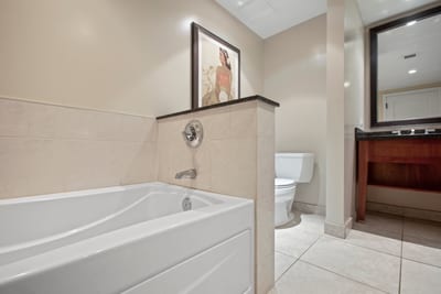 Modern soaking tub with elegant tile accents and serene spa atmosphere. HKH-545
