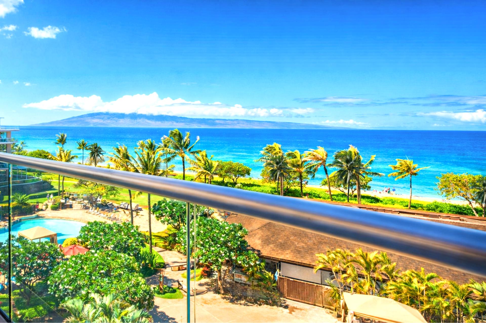 Sweeping fifth-floor views across the inner courtyard, pools, and sparkling Pacific.