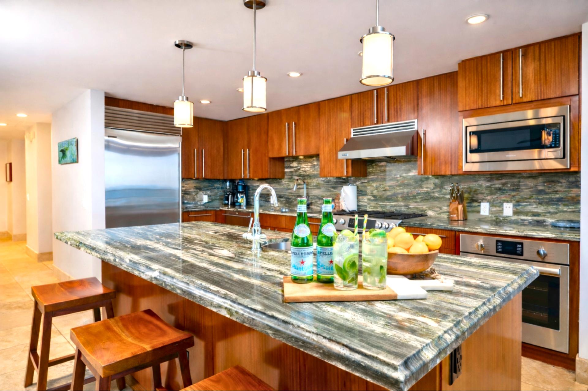 Polished stone surfaces and rich wood cabinetry combine elegance and functionality.
