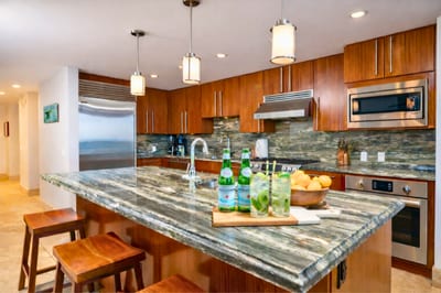 Polished stone surfaces and rich wood cabinetry combine elegance and functionality. HKH-550