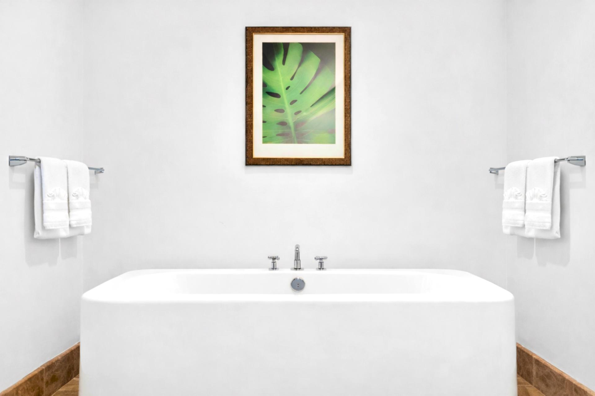 Spa-inspired ensuite with soaking tub and serene white finishes.