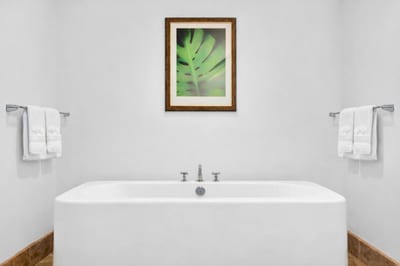 Spa-inspired ensuite with soaking tub and serene white finishes. HKH-550