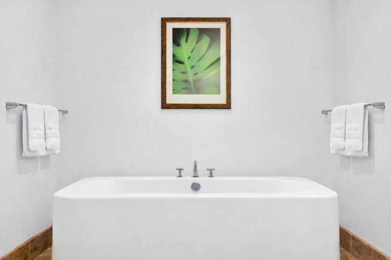 Spa-inspired ensuite with soaking tub and serene white finishes.