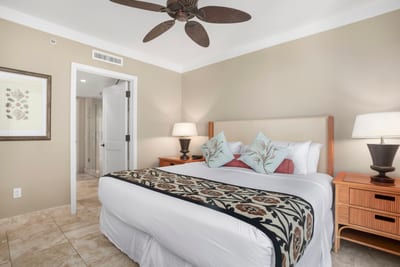Cozy island bedroom with spa access, tropical pillows, peaceful ambiance.
