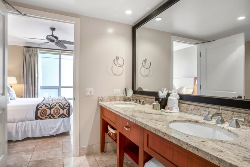 Elegant bathroom with granite counters, double sinks, and tropical comfort nearby. HKH-609