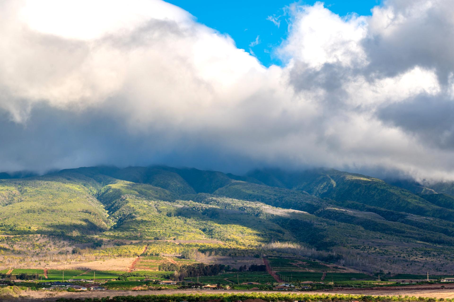 Marvel at Maui’s majestic mountain views, where lush valleys meet rolling clouds.