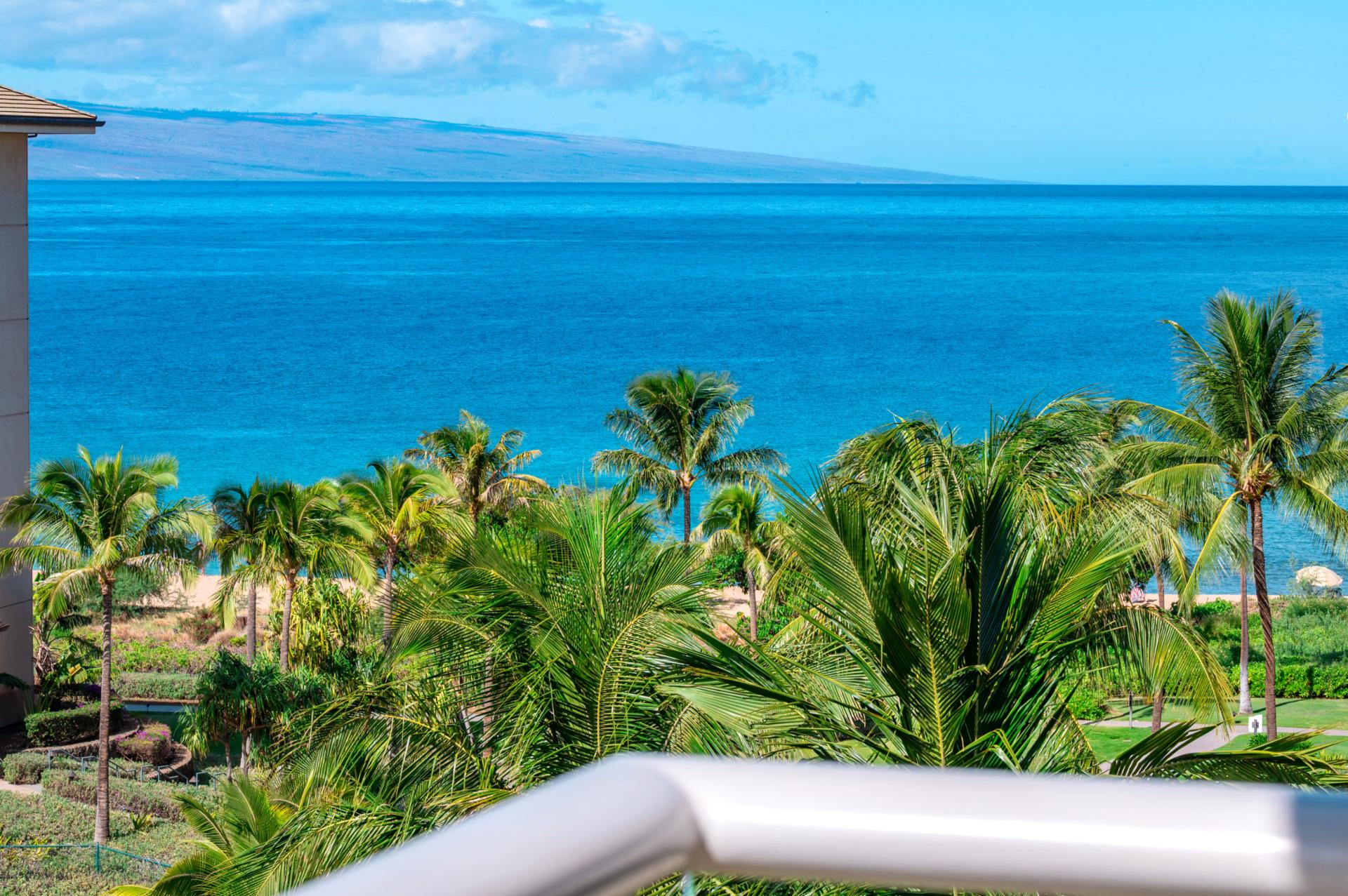 Balcony paradise: ocean breeze, swaying palms, tranquil tropical island view.