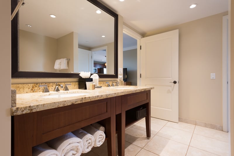 Spa-style guest bathroom at Honua Kai Hokulani 620 — dual vanity, granite countertops, and hotel-quality rolled towels