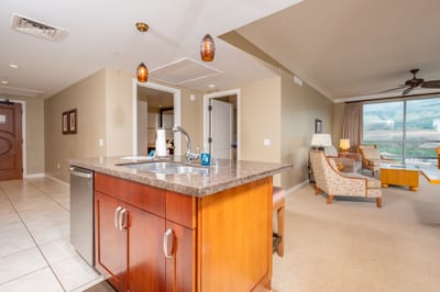 Modern island kitchen with open layout and mountain-view living space.