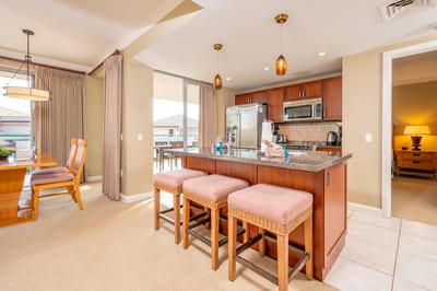 Island kitchen and dining area with balcony light and cozy comfort.