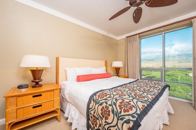 Bright bedroom sanctuary with lush mountain views and tropical elegance.