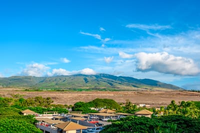 Majestic mountain view over tropical landscape and resort-style parking area.