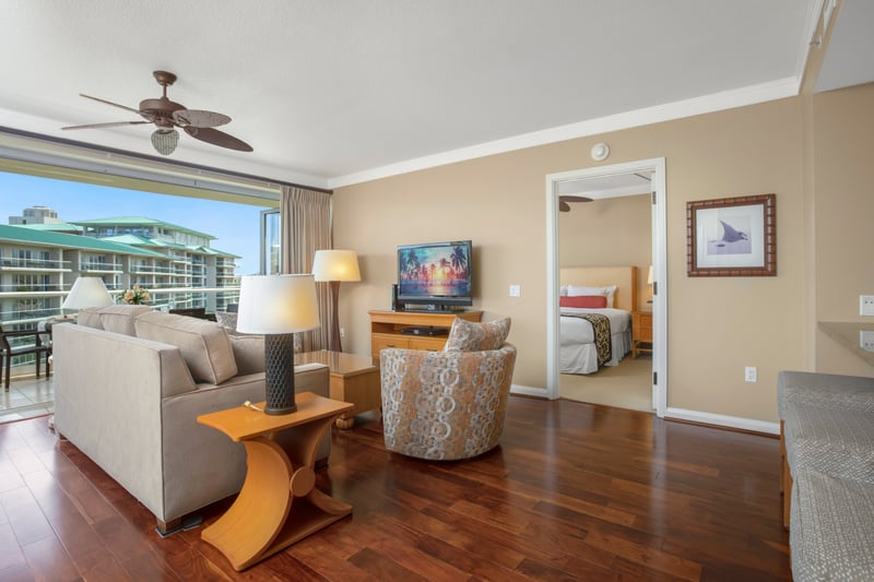 Spacious suite with open living, cozy bedroom, and balcony views.