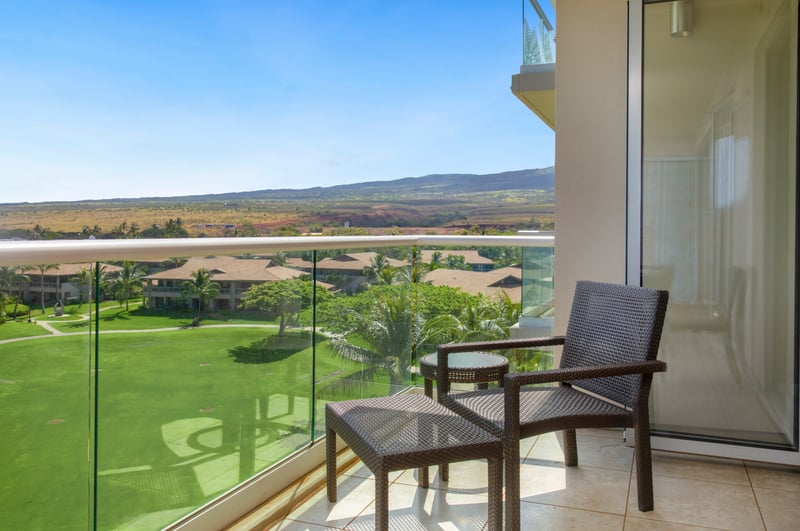 Private balcony with scenic mountain views and lush green landscape.