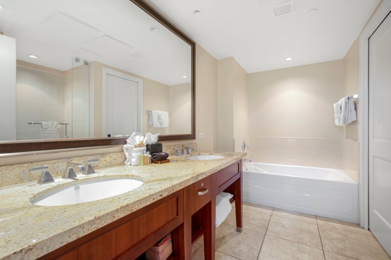 Bright bathroom with double vanity, soaking tub, and spacious layout.