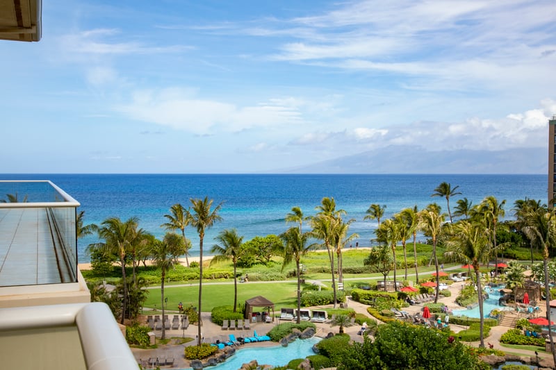 Tropical paradise with ocean views, palm trees, and luxury pools.