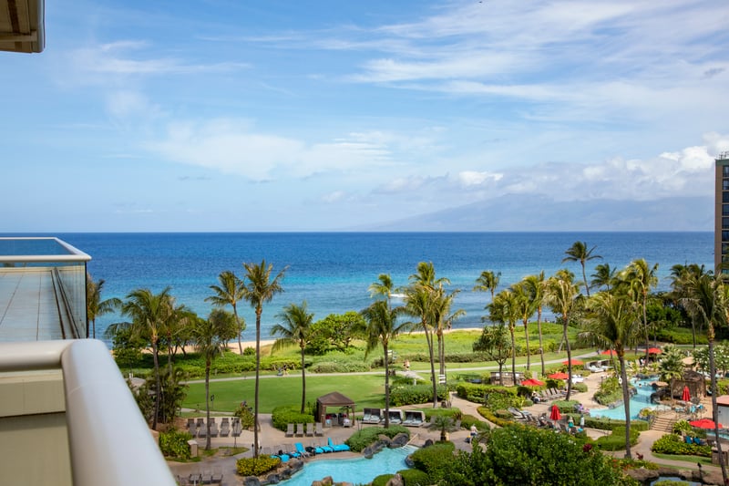 Oceanfront resort with palm trees, pools, and breathtaking island views.