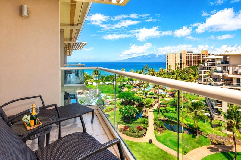 The lanai looks out over the resort pool and gardens to the open ocean beyond