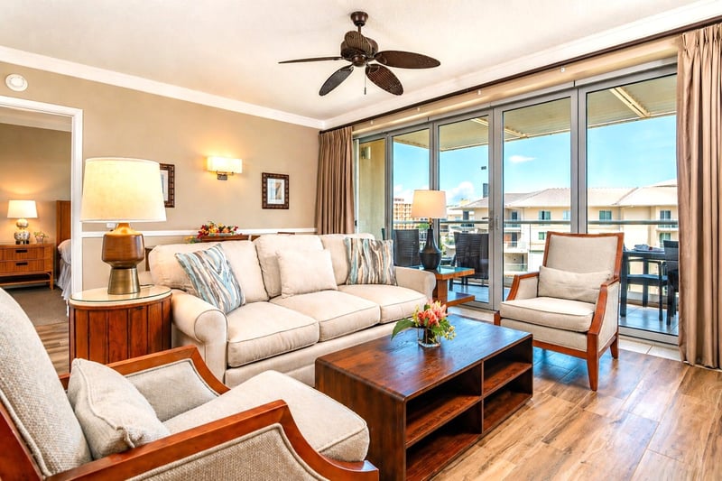 The living area is airy and well-appointed, with sliding doors that open directly to the lanai