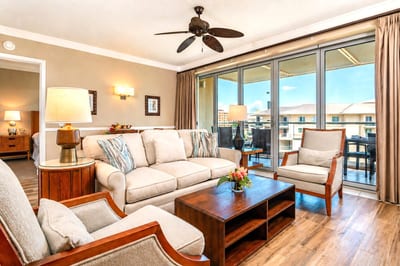 The living area is airy and well-appointed, with sliding doors that open directly to the lanai