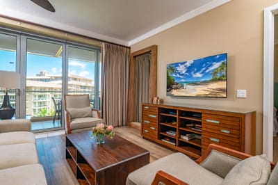 A quiet corner of the living area with warm wood furnishings and soft, natural light
