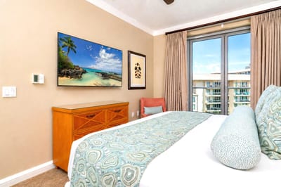 The guest bedroom features a king size bed and beautiful floor to ceiling windows that let in the natural light