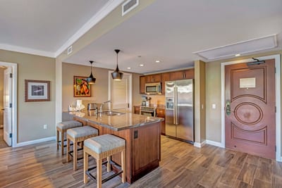 Enter into elegance with this open-concept kitchen, granite island, and bar seating for relaxed gatherings