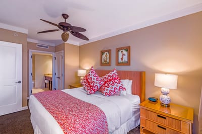 Cozy tropical bedroom with colorful accents and ensuite bathroom access.