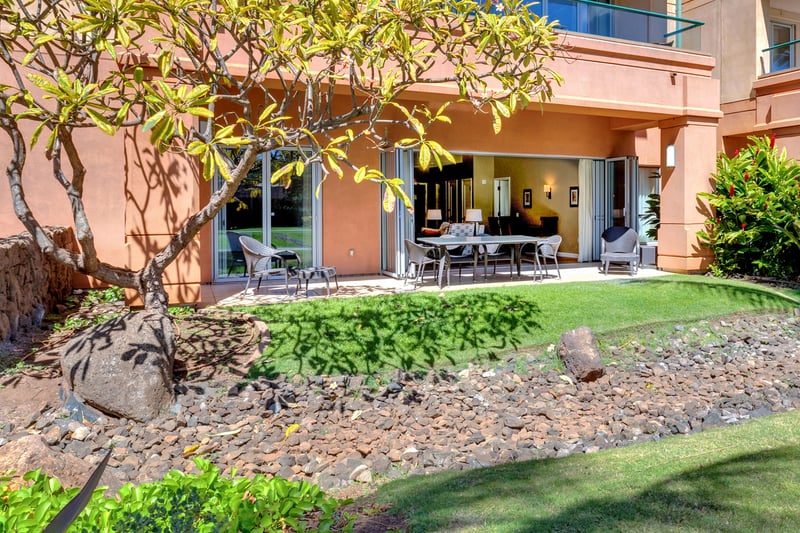 Private garden lanai with outdoor dining and lush tropical setting.