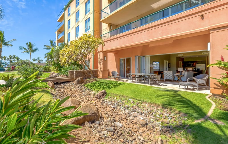 Tropical ground-floor retreat with open lanai and lush landscaping views.